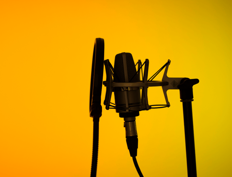 a microphone in a microphone stand in front of a yellow background