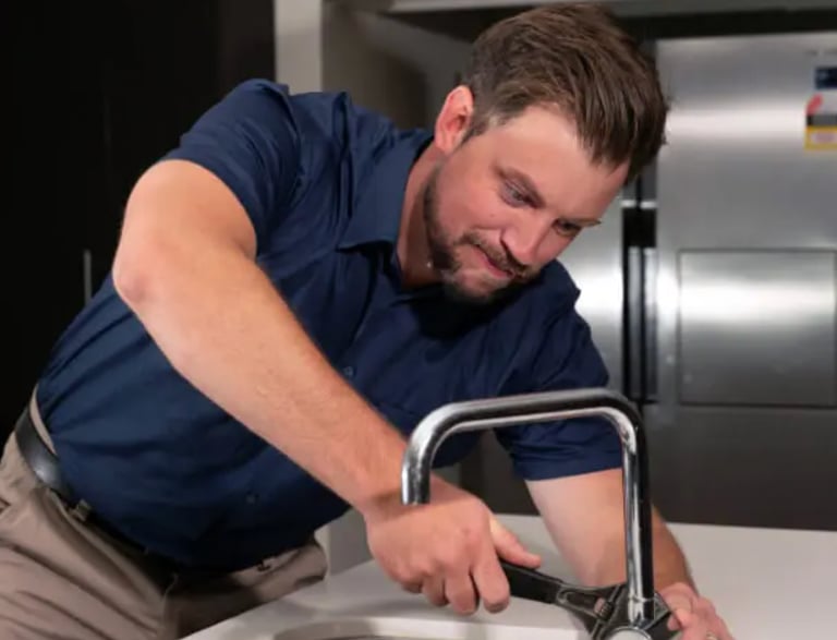 plumber fixing sink