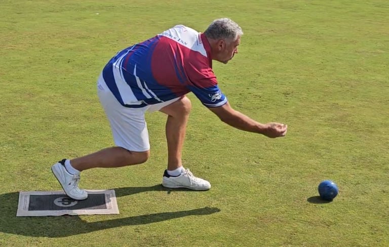 a porthcawl bowls club lawn bowler releasing his bowl