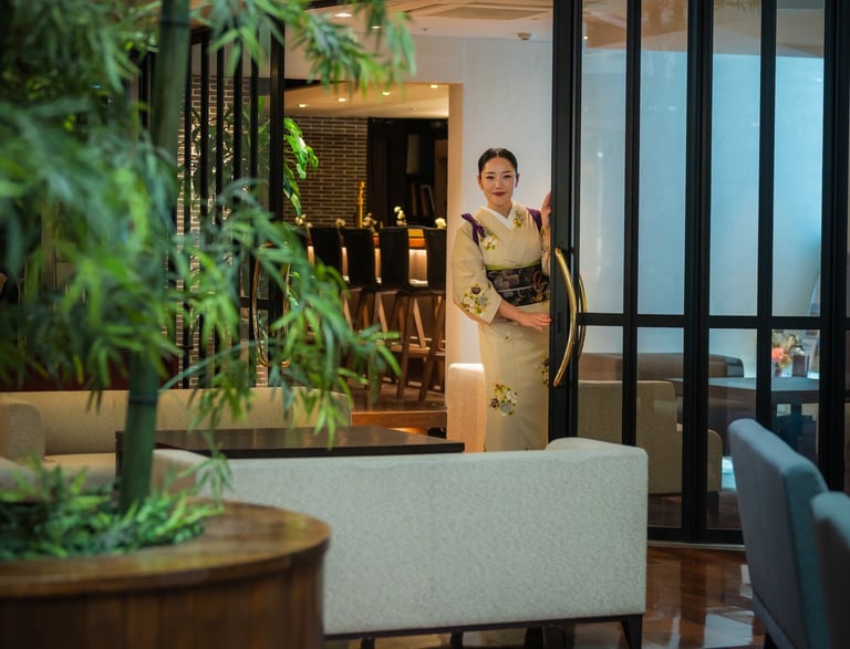 a woman dressed in kimono greeting customers in the lobby of the japanese hotel Chaharu in Matsuyama