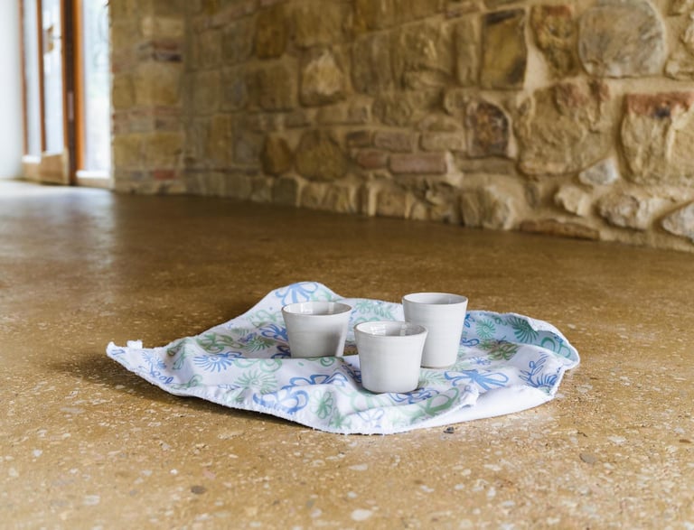espresso cups resting on the shiny polished rammed earth floor