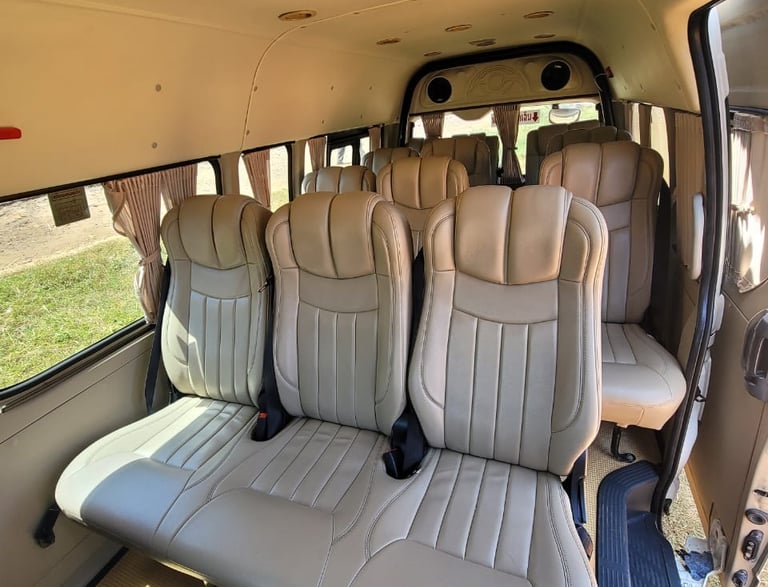 Luxury & spacious passenger van interior with beige reclining leather seats 