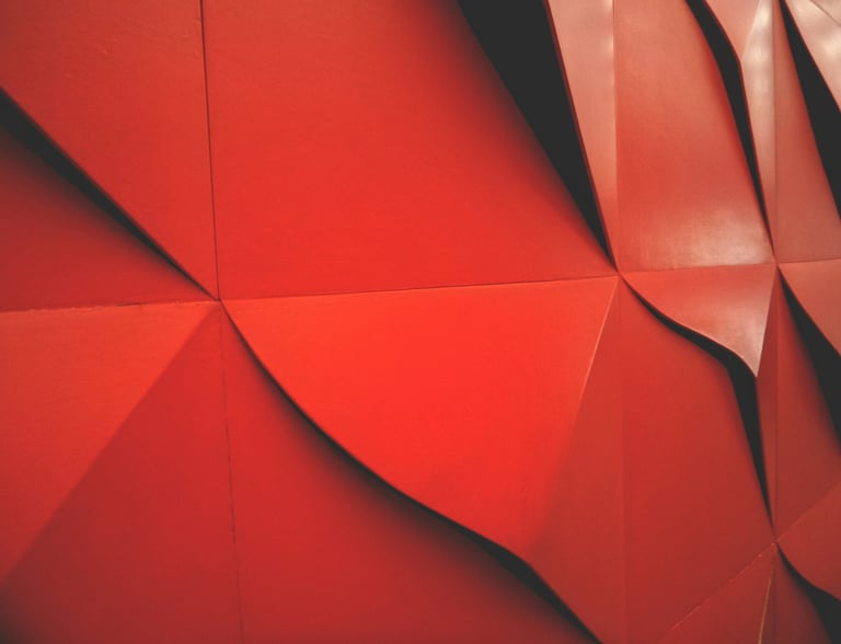 a red wall with large wavered wallpapered structure