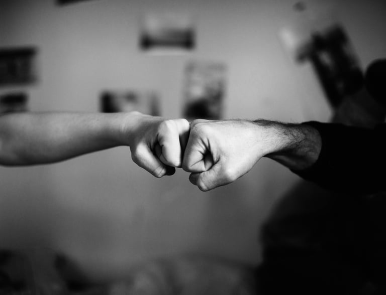 black and white photo of a fist bump