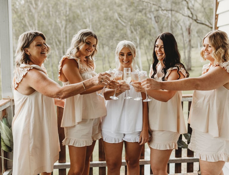 a group of women who are holding champagne flutes