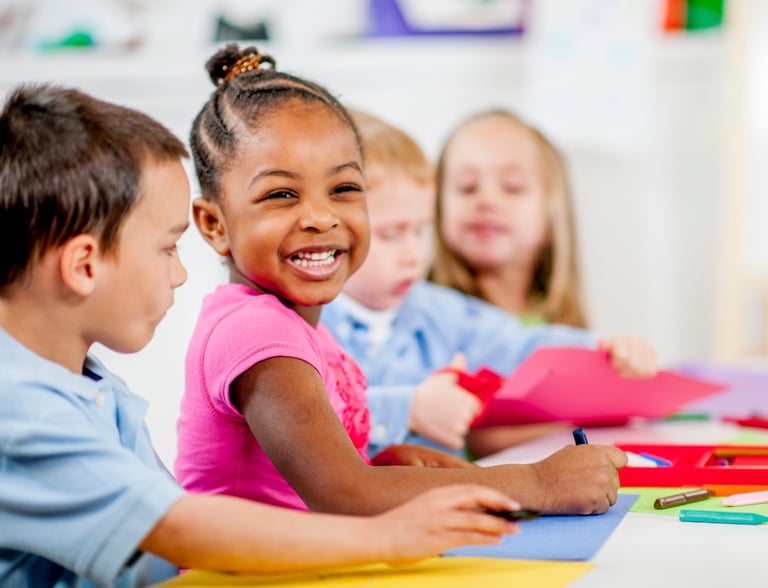 Children smiling and coloring