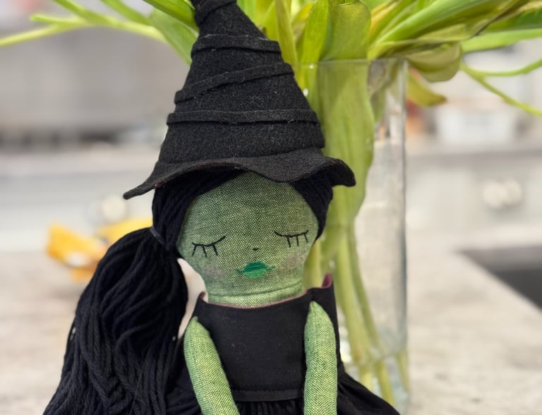 a stuffed toy of a green witch