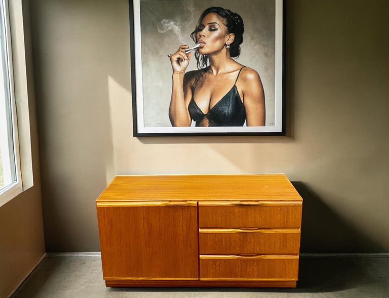 Small McIntosh teak cupboard in Mid Century Modern style with practical storage and timeless vintage appeal.