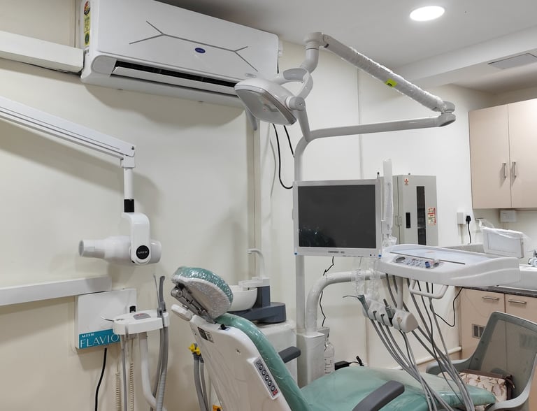 Modern dental office interior with professional examination chair, surgical light, and digital X-ray machine.