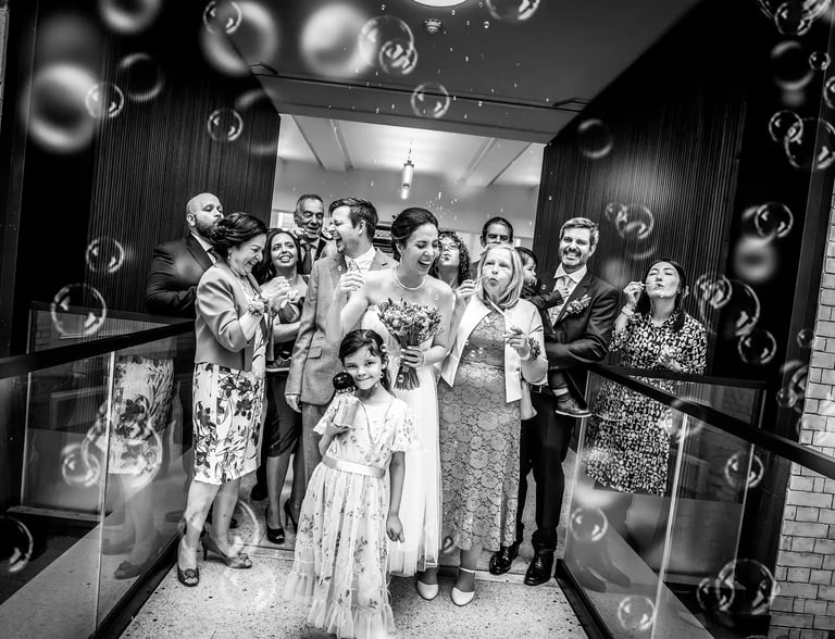 Ben and Patricia with bubbles on the internal bridge at Lambeth Town Hall
