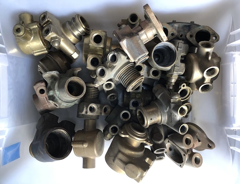 A bin full of old brass pumps inside an assemblage artist's studio.