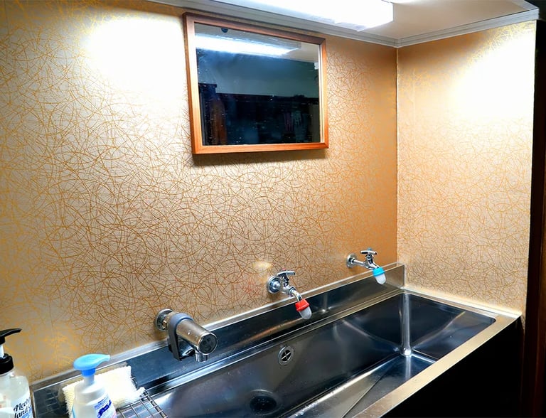 Clean and well-maintained shared vanity area at Ryokan Nakadaya Asakusa for international guests.