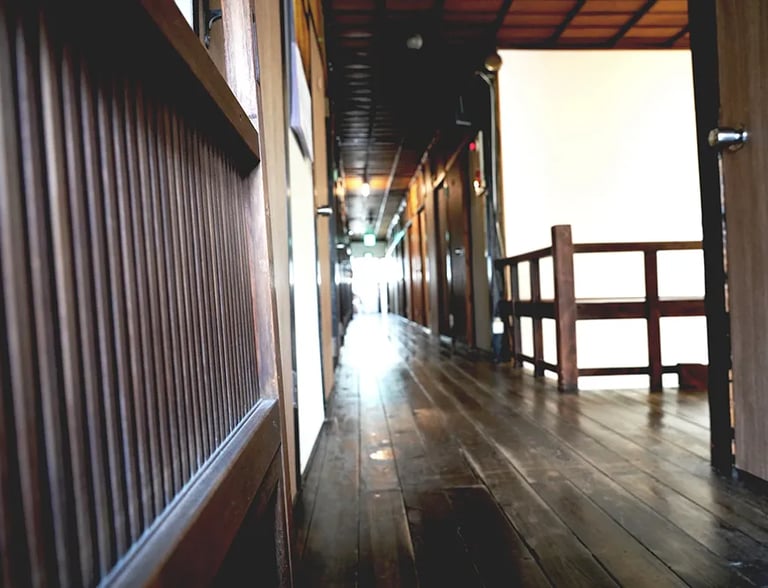 The warm texture of aged wooden flooring at Nakadaya, an authentic Japanese inn.