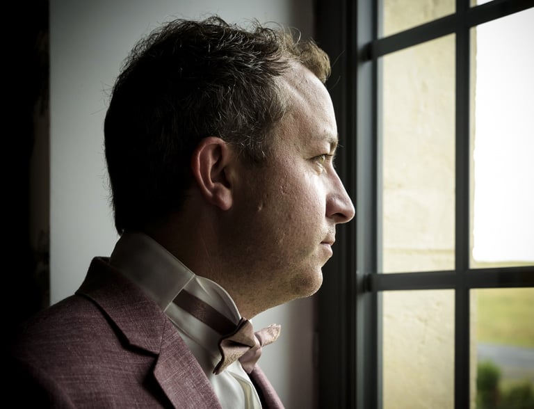 a man in a suit and bow tie