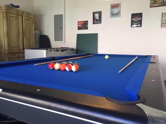 a pool table in a games room in florida villa