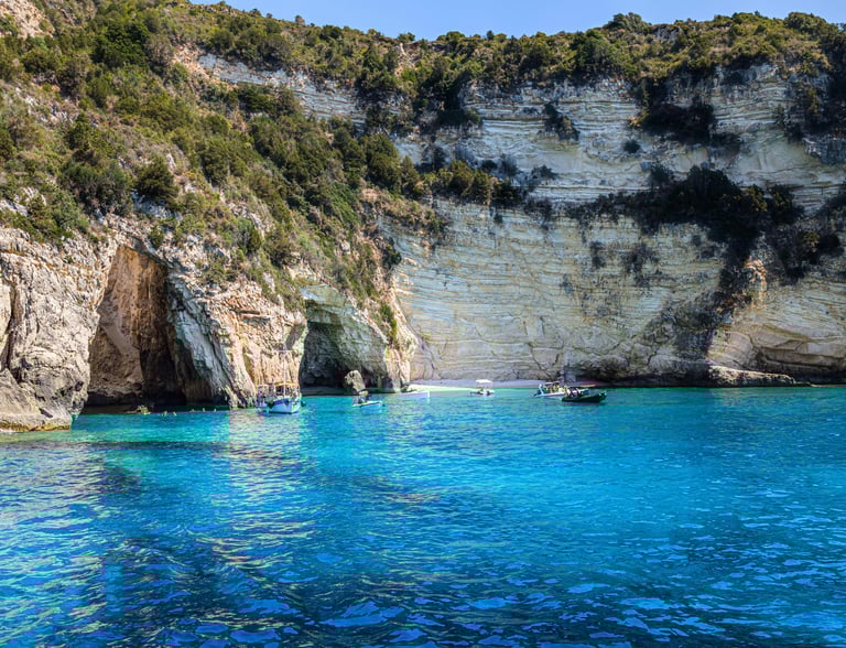 a boat in the water near a cliff