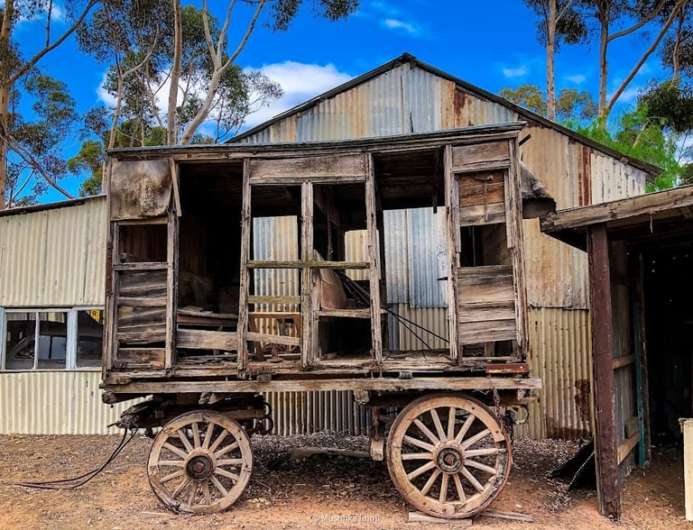Rustic antique wooden carriage with spoked wheels parked iat Old Tailem Town