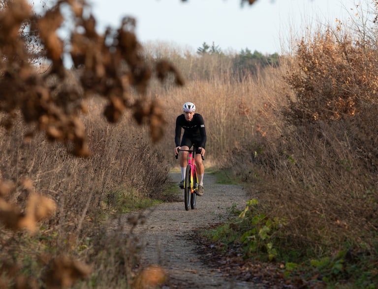 a man riding a bike down a path