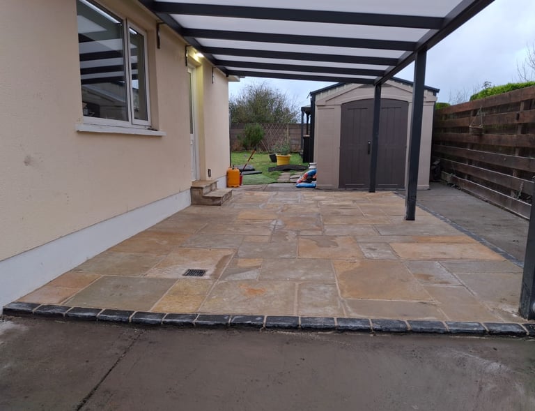 The after picture of construction which features a newly laid patio