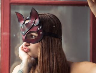 a woman in a leather cat mask