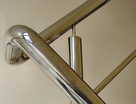 a metal stair case with a metal handrail
