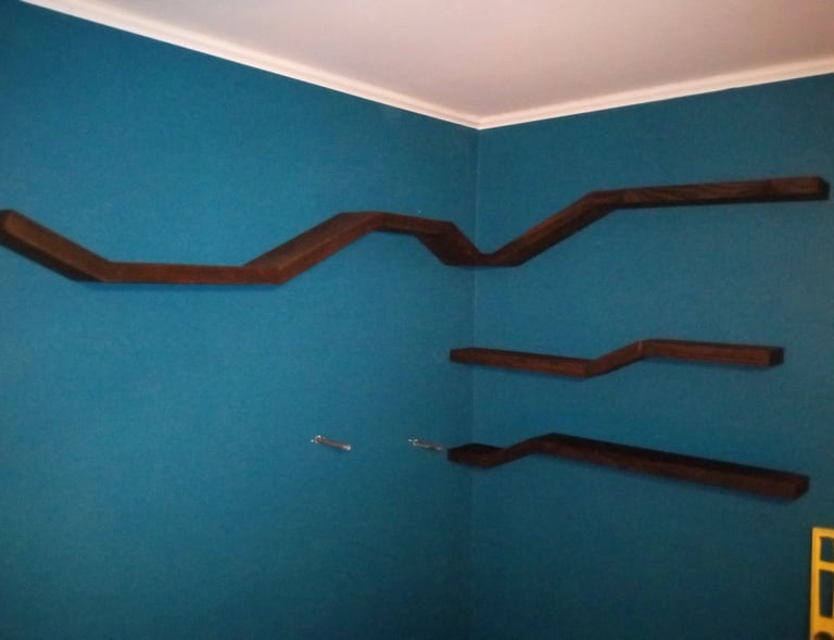 Four floating shelves mounted on wall