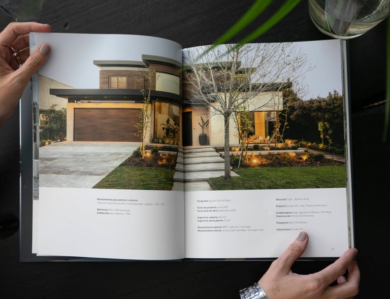 a person holding a book with a picture of a house