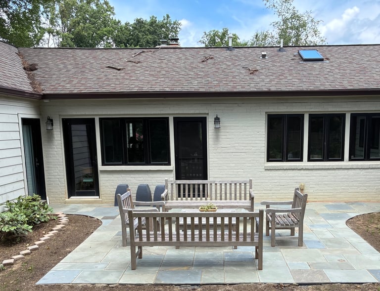Backyard patio with curved walkways connecting to outside doors