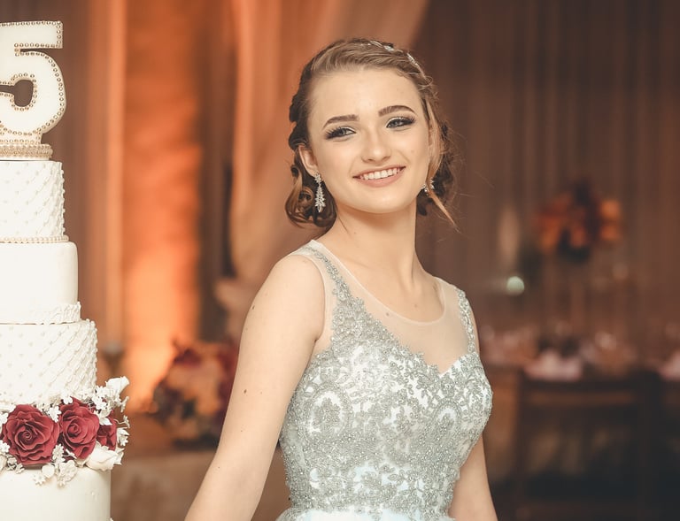 a woman in a dress standing next to a large cake