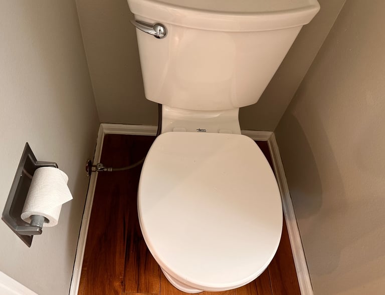Sanitized toilet with clean surroundings – SparkEaseCleaning detailed restroom cleaning services.