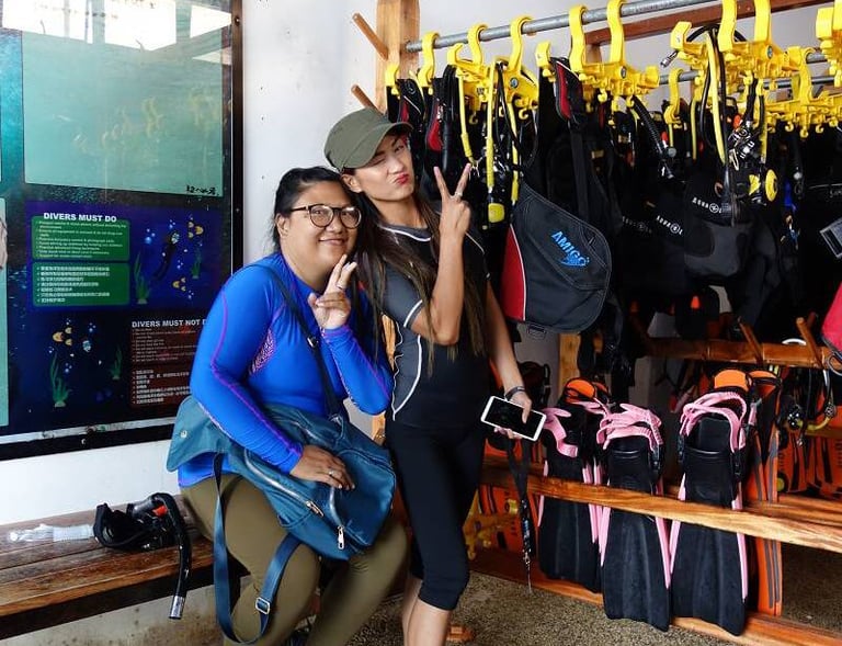 2 girls prepare for diving posing for a picture