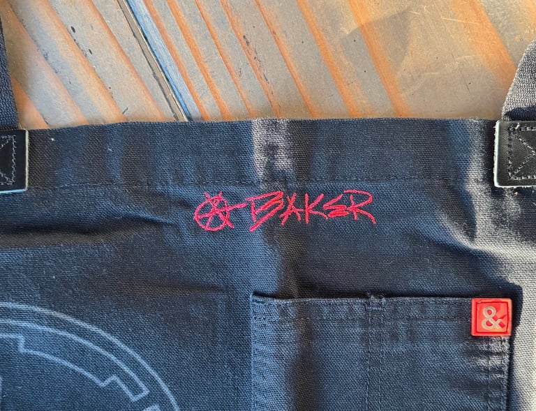 an apron with handwriting embroidered on it