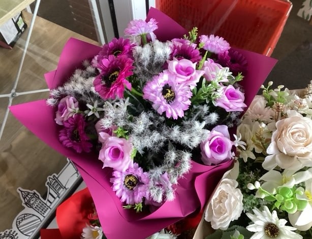 a bouquet of flowers in a vase on a table