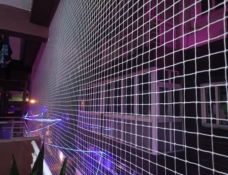 Close-up of a freshly installed pigeon safety net tightly secured on a balcony in Sarjapura Road.