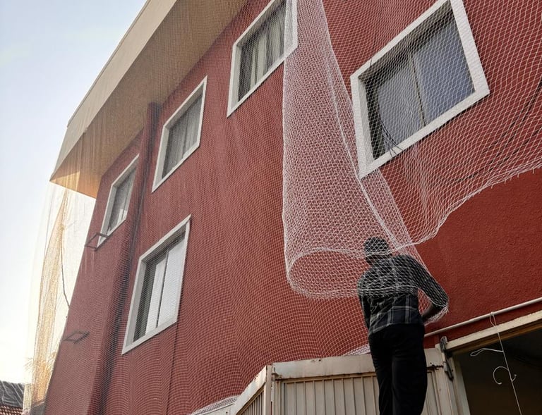 View of a clean, netted duct area preventing pigeons from nesting in a busy malleshwaram neighborhoo