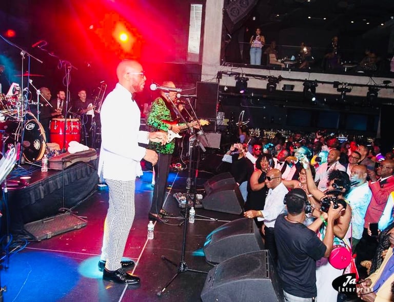 Clinton Benoit standing on a stage with a microphone at the Melrose Ballroom in Long Island City