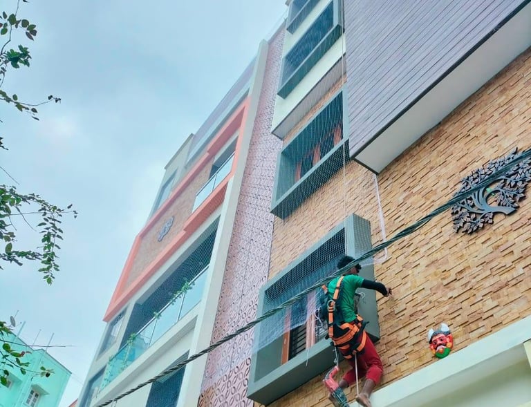 Close-up of sturdy white mesh netting installed over an apartment duct to keep pigeons out.