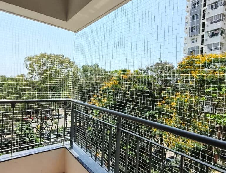 Close-up of a sturdy balcony safety net securely installed in a high-rise apartment in Vizag.