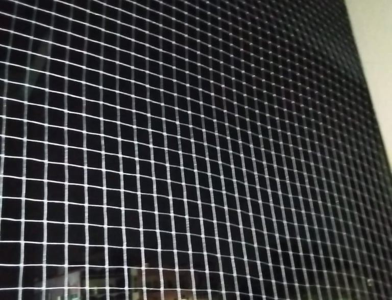 A family enjoying their balcony space safely, thanks to the pigeon net installed by Arjilli Enterpri