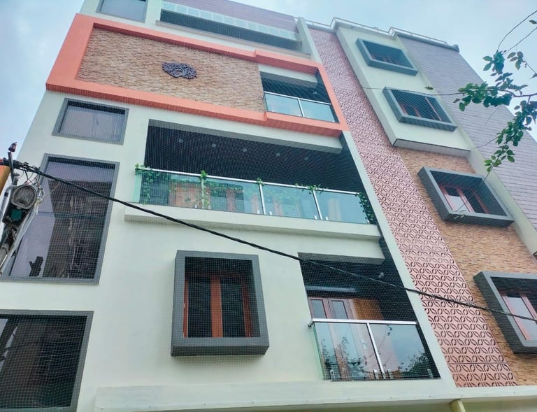 Evening shot of a balcony with safety netting, showing how it blends seamlessly with the building’s