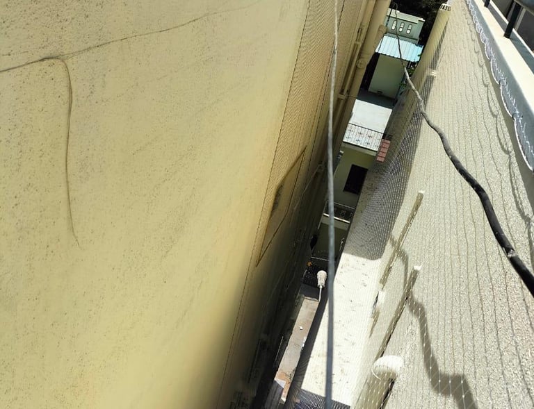 Close-up of a sturdy terrace safety net installed on a Chennai rooftop, showing fine mesh details.