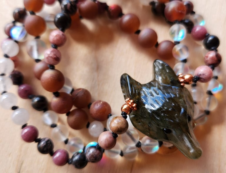Hand-knotted gemstone mala necklace with 108 beads, created by Tina Medina for spiritual meditation and energy healing