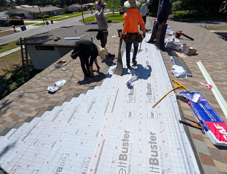 a group of men standing on a roof with a roof that has been painted white