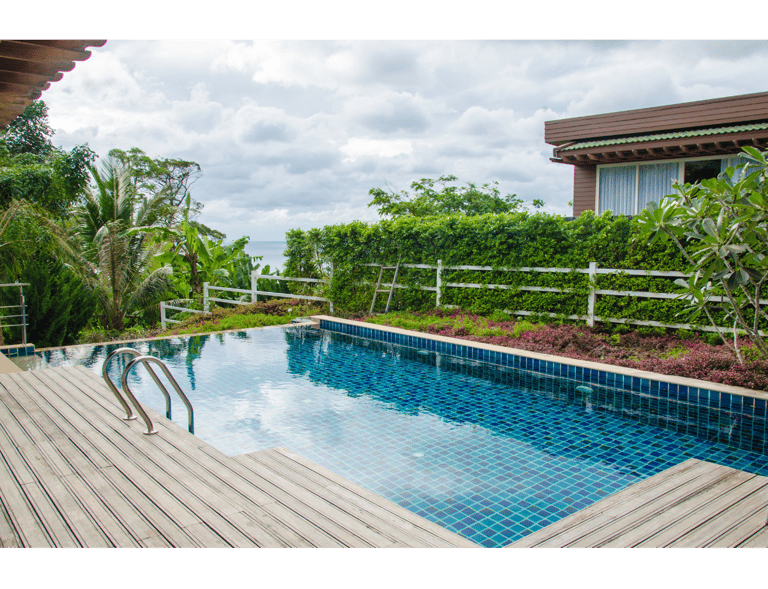 Beautiful setting with wood-planked deck surrounding a zero-edge square pool