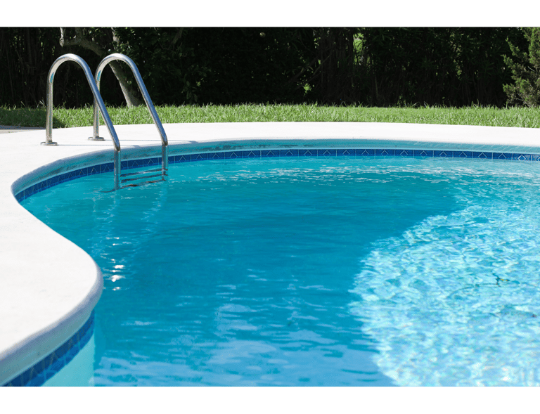 Medium shot of a kidney-shaped clear-blue pool with ladder