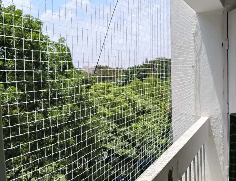 Wide shot showing a high-rise balcony fully secured with Junia Safety Nets in Koramangala.