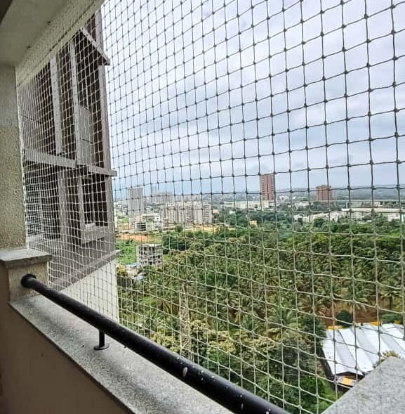 Close-up of a sturdy balcony safety net installed on a Koramangala apartment balcony.