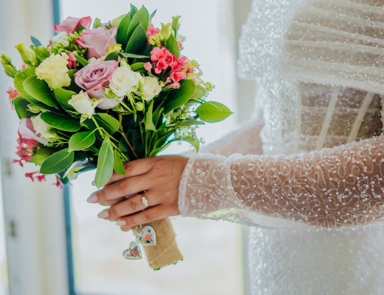 a bridesmaid holding a bouquet of flowers