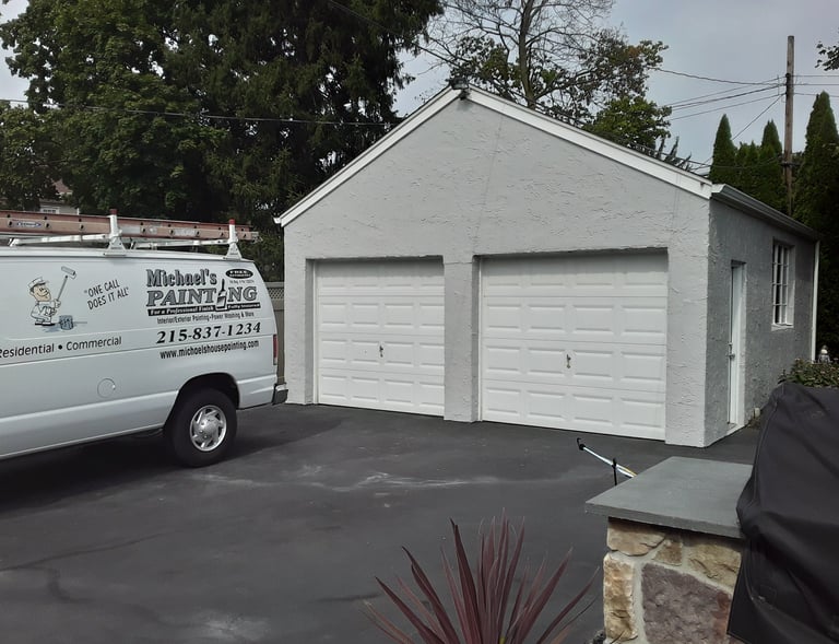 a van in the driveway and a garage