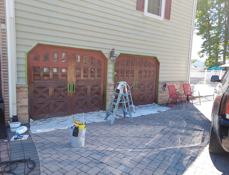 a drive way a car and ladders around garage